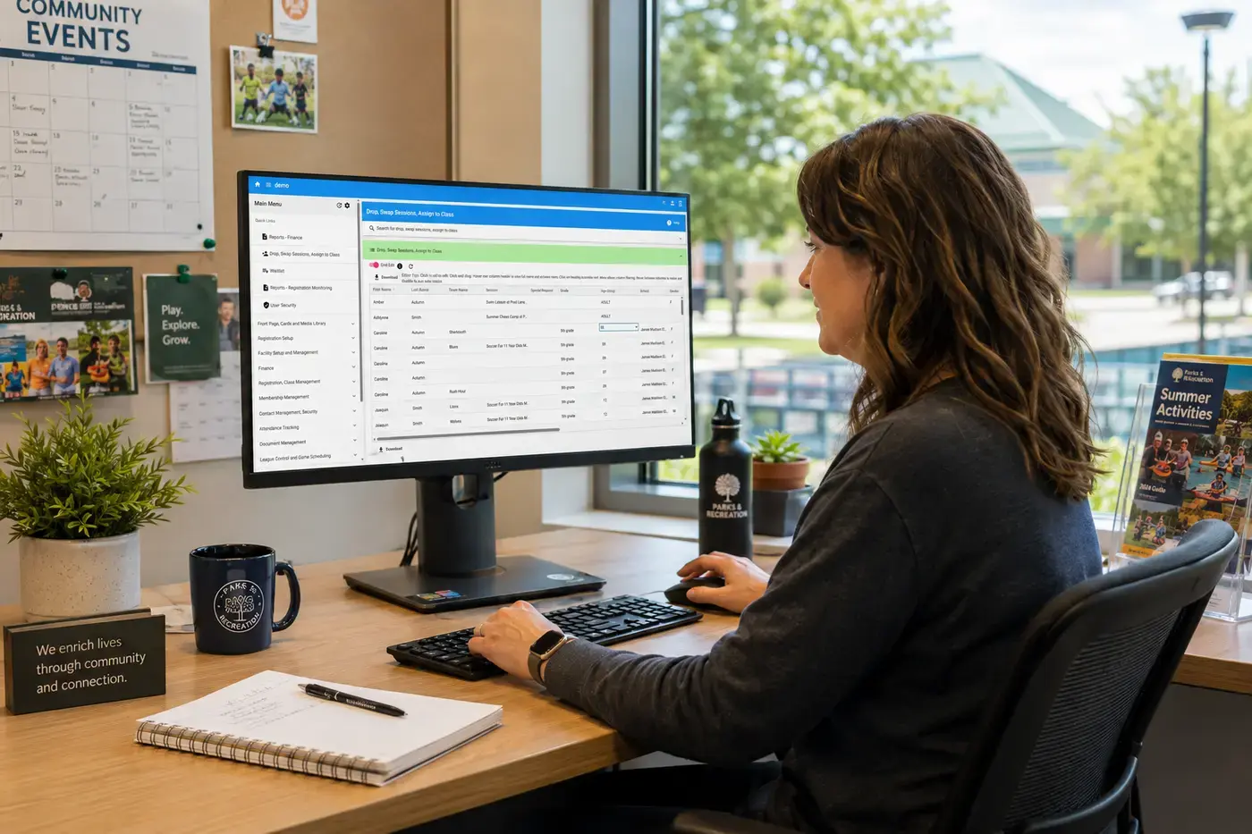 A recreation administrator using Cogran at a desk overlooking a community facility